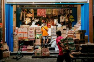 Men carrying boxes in a busy local store in Semarang, Central Java, Indonesia.