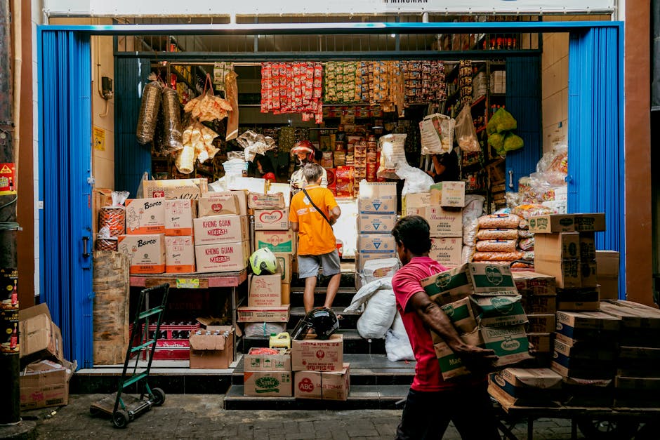 Men carrying boxes in a busy local store in Semarang, Central Java, Indonesia.
